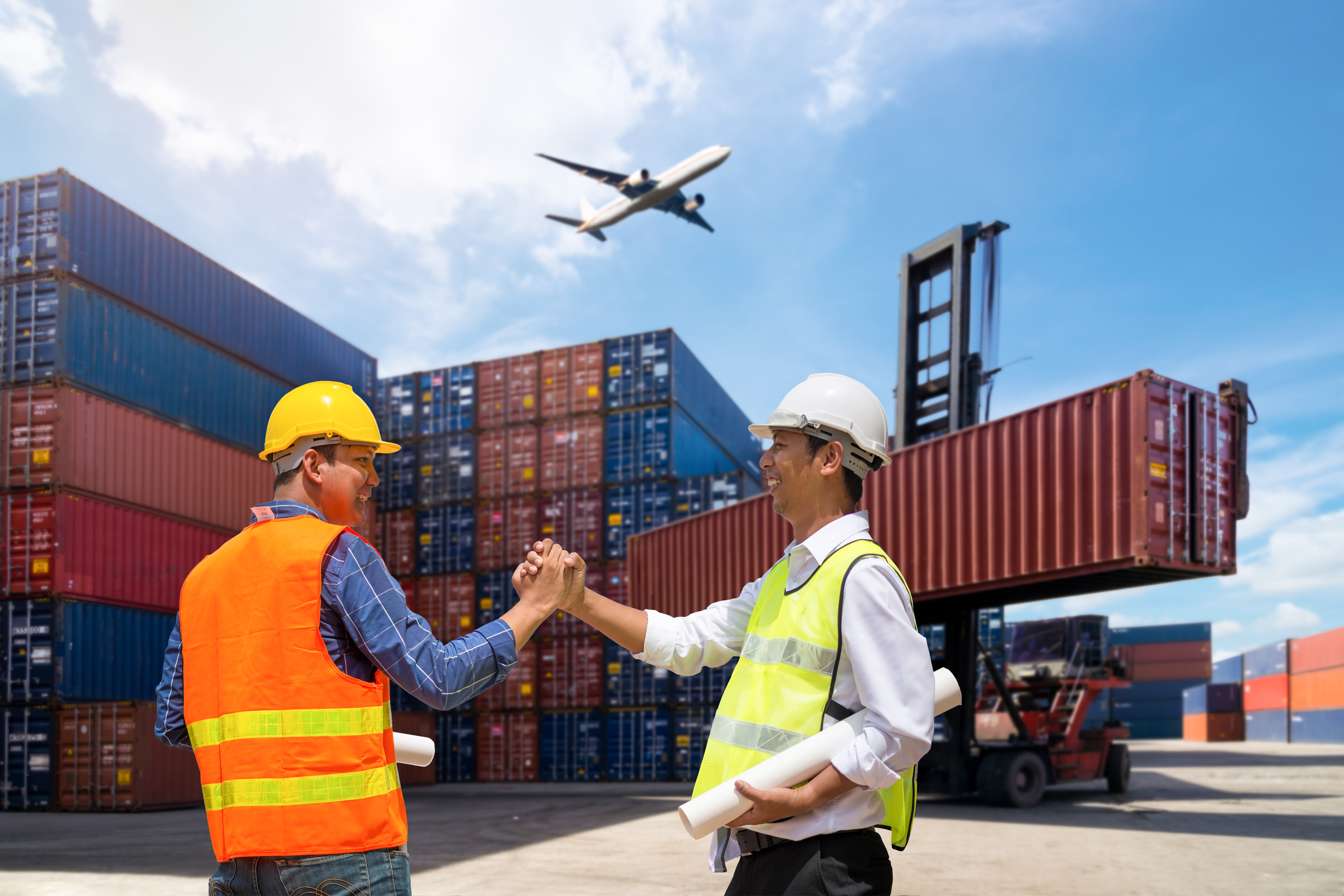 Foreman and Businessman control loading Containers box from Cargo freight ship